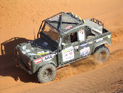 Land Rover Defender 100 at speed across dunes in Outback Challenge